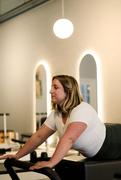 Total Body Control Pilates class with instructor assistance