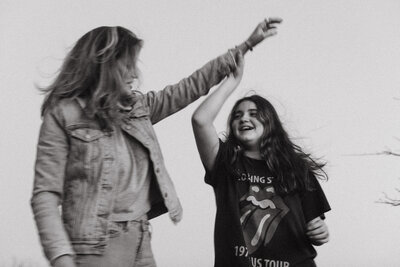 Mother and daughter giving each other a high five