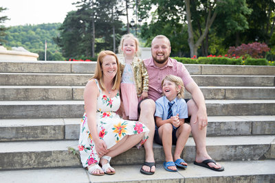 family sitting on steps at Gage Park Hamilton