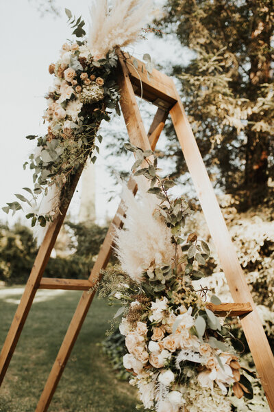 wedding arch with flowers and dried pampas