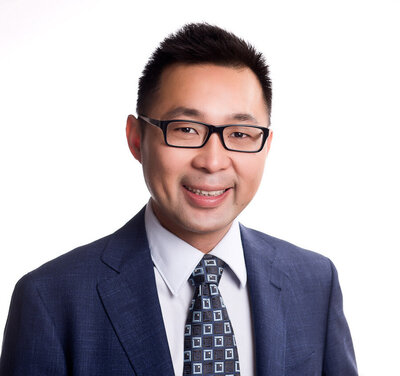 Asian man wearing glasses professional headshot