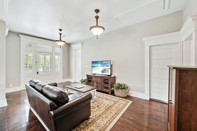 Comfortable seating and large screen TV in living room of historic vacation rental home in downtown Waco, TX