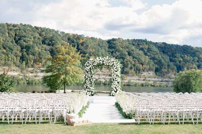 floral arch for a ceremony in front of a beautiful waterfront view  designed by Sirpilla Soirees, wedding planners in Cleveland Ohio