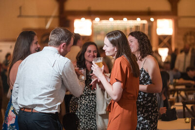 guests chitchating during cocktail hour at barnwood events in madison, winconsin.