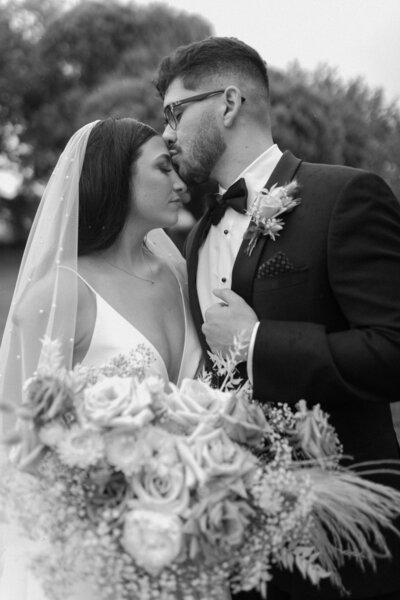Couple Image with Bridal Bouquet - Bre & Chris | Converted Basketball Court Wedding - Brides