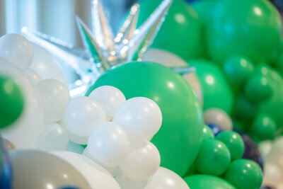 Green and white balloons from party planned in DC