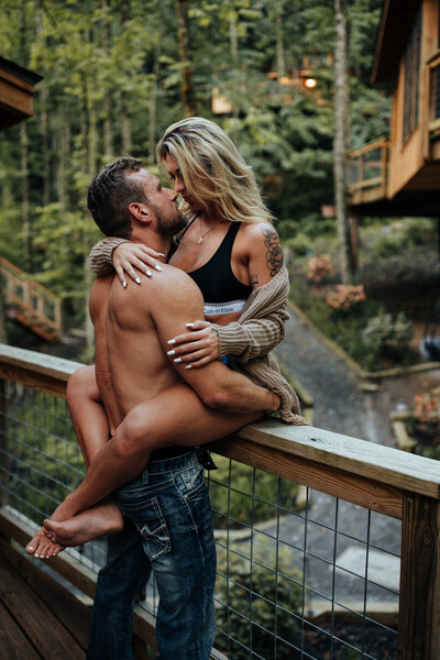 couple embracing on bridge
