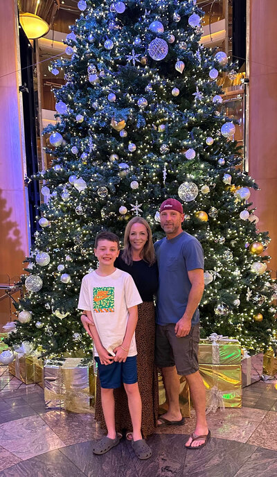 Lacey and her family in front of a Christmas tree