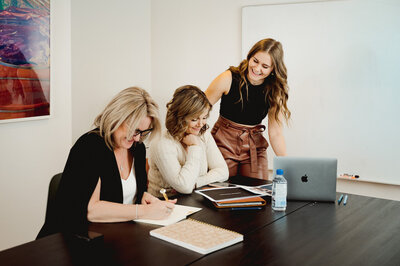 Three ladies working at a boardroom table