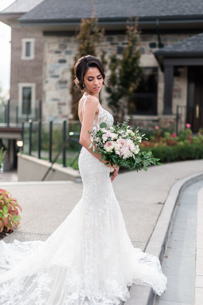 Portrait of the bride wearing a high couture dress with her bouquet at Arlington Estate Toronto