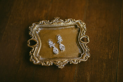 earrings sitting on a gold tray