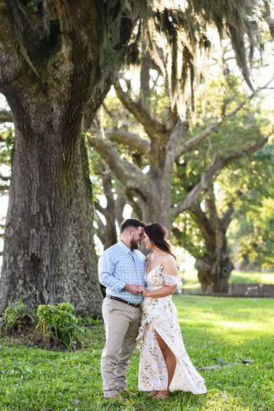 Beautiful engagement Photography: Couple in front of oaks with Spanish moss in Ocean Springs, Mississippi