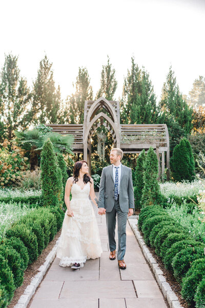bride and groom walk along path at Sarah P Duke Gardens