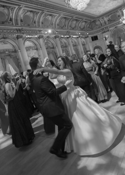 The bride and groom were dancing the night away in the ballroom of the Plaza Hotel in New York City,