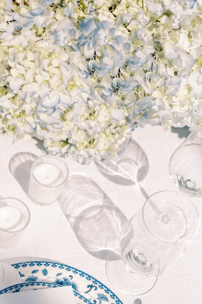 Photo of reception table decor with blue and white hydrangeas at wedding at Castle and Key Distillery in Lexington Kentucky photographed by Lexington Kentucky luxury wedding photographer Magnolia Tree Photo Company