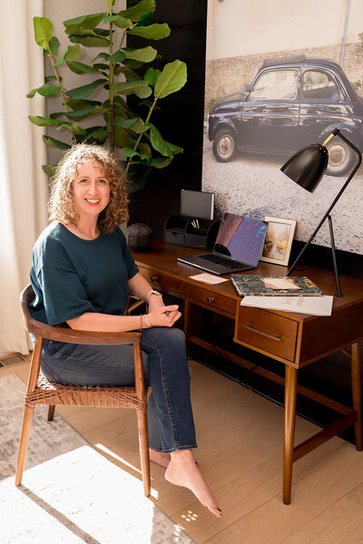Lauren Haug reviewing real estate documents while preparing a home listing in Loveland, CO
