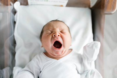 Newborn baby yawning during Fresh 48 session with Laurie Baker