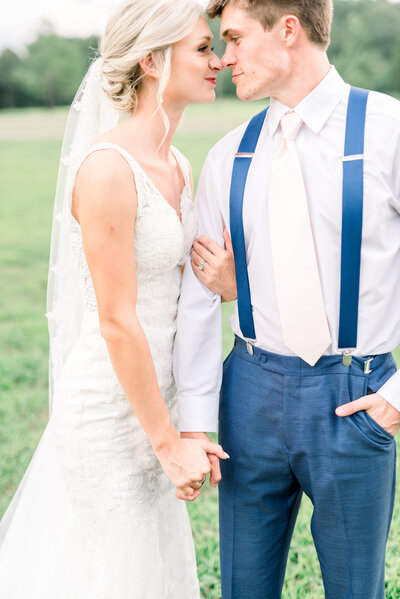 Bride and groom in navy suit at blush wedding
