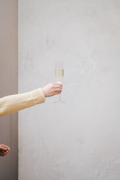 Woman's hand holding a champagne glass