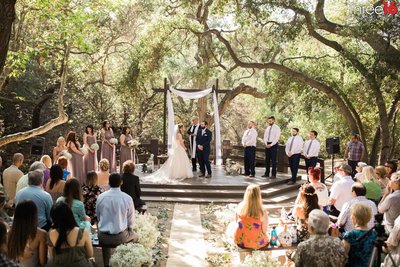 Bride and Groom take their oath during wedding ceremony outdoors at the Oak Canyon Nature Center wedding venue