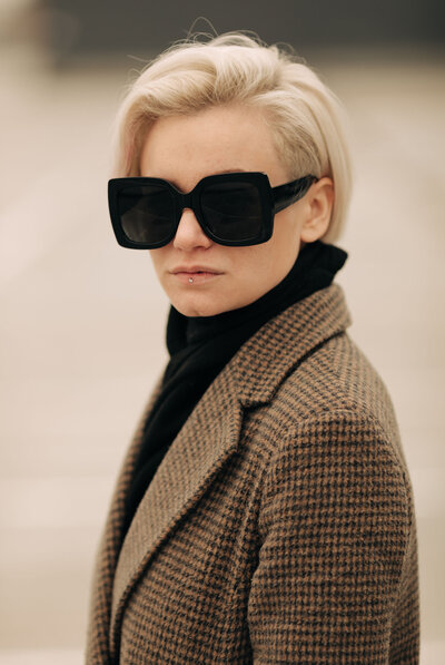 fashionable woman wearing sunglasses and a blazer