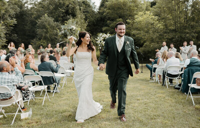 Bride and groom walking down aisle after ceremony