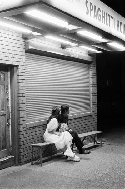 35mm film photo of couple sitting underneath fluorescent lights in vancouver