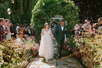 Bride and groom outdoor garden ceremony archway