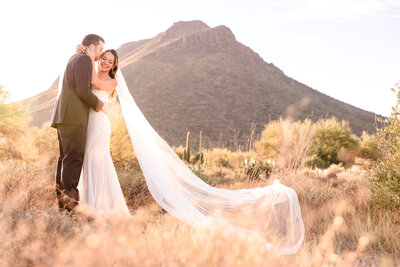 Bride and Groom embrace in the desert of Tucson, Arizona.