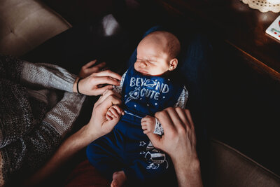 newborn baby girl in moms arms during boston newborn photo session