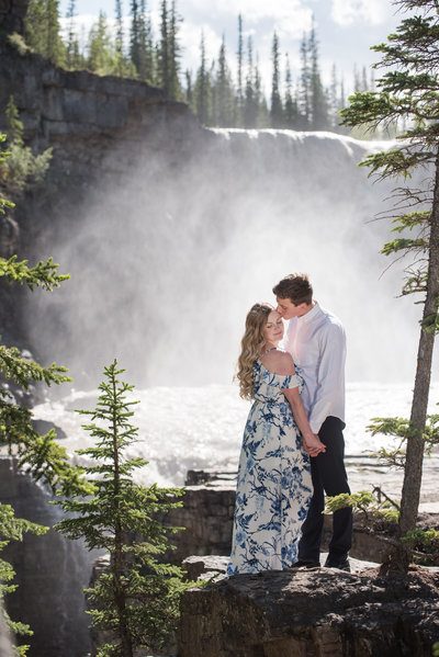engagement photo of couple in front of waterfall