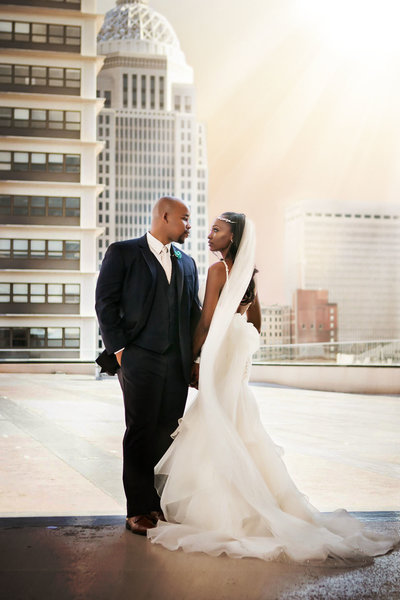 African American wedding on top of the Galt House Hotel overlooking Louisville skyline