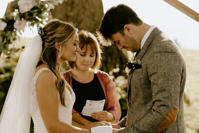 A couple praying together during their wedding ceremony