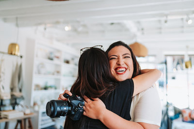 two women hugging after photo shoot