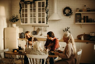family sitting at their dining room table to eat dinner