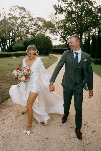 Hayley and Joel walking the grounds of Wallalong House on their wedding day in the Hunter Valley