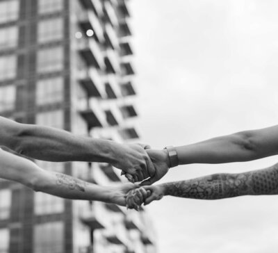 close up of two hands holding each other tightly to spin