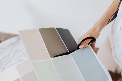Person cutting a color palette paper with scissors