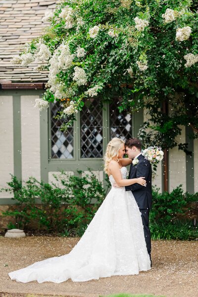 bride and groom surrounded by falling petals by Knoxville Wedding Photographer Amanda May Photos