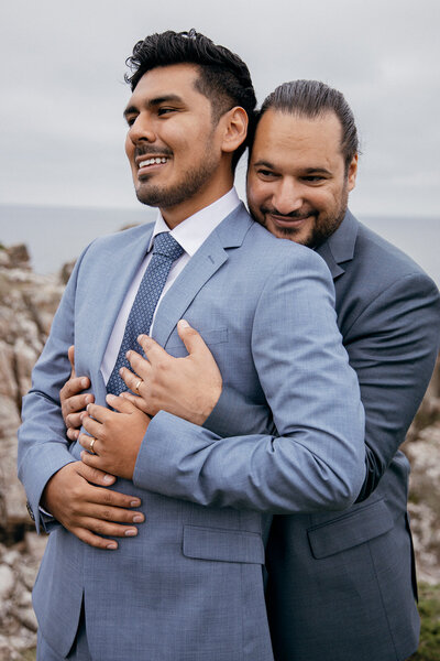 Gay couple embracing as they just had micro wedding on Bornholm island in Europe
