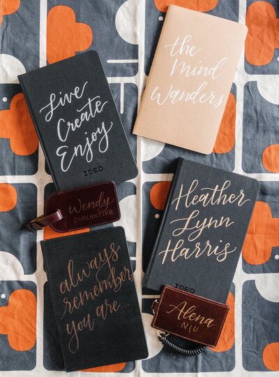 Notebooks personalized for a corporate event, with live calligraphy lettering