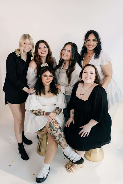 A candid group photo of SoCo stylists laughing and having fun, reflecting the positive salon culture.