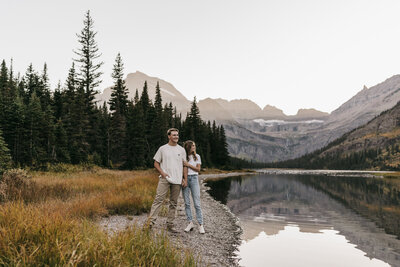 A couple poses during their engagement session in Glacier National Park.