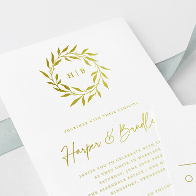 gold foil wedding invitation with botanical wreath