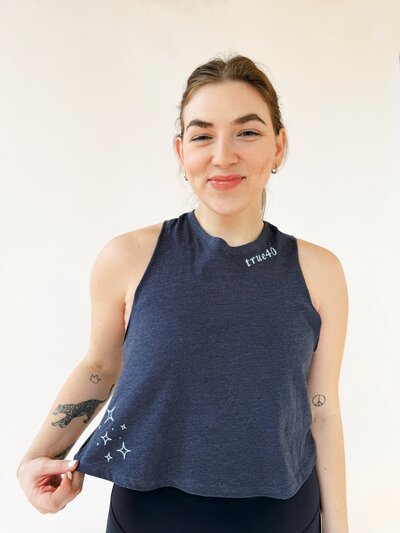 woman wearing blue high neck cropped tank with true40 logo and stars
