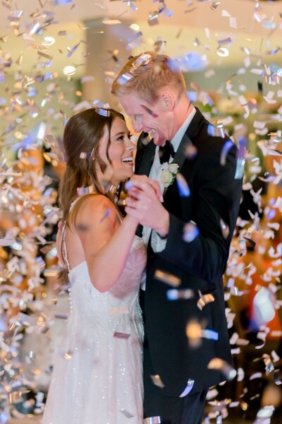 Bride and groom dance under confetti