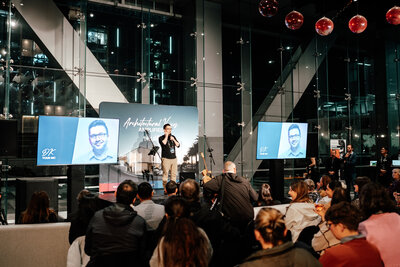 Man standing on a stage doing a presentation at the Teulo Architectural Voices Event at Spectra in Auckland - Zanthe Vorsatz Photography