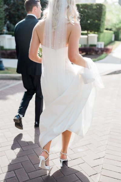 A bride and groom walking in the streets on their wedding day at the Alfond Inn in Winter Park, Florida.