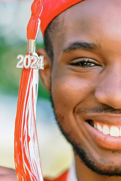 Closeup portrait of a medical school graduate with his tassel next to his eye
