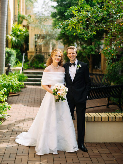 Bride and groom standing together, looking at the camera during their wedding in Tampa, Florida.